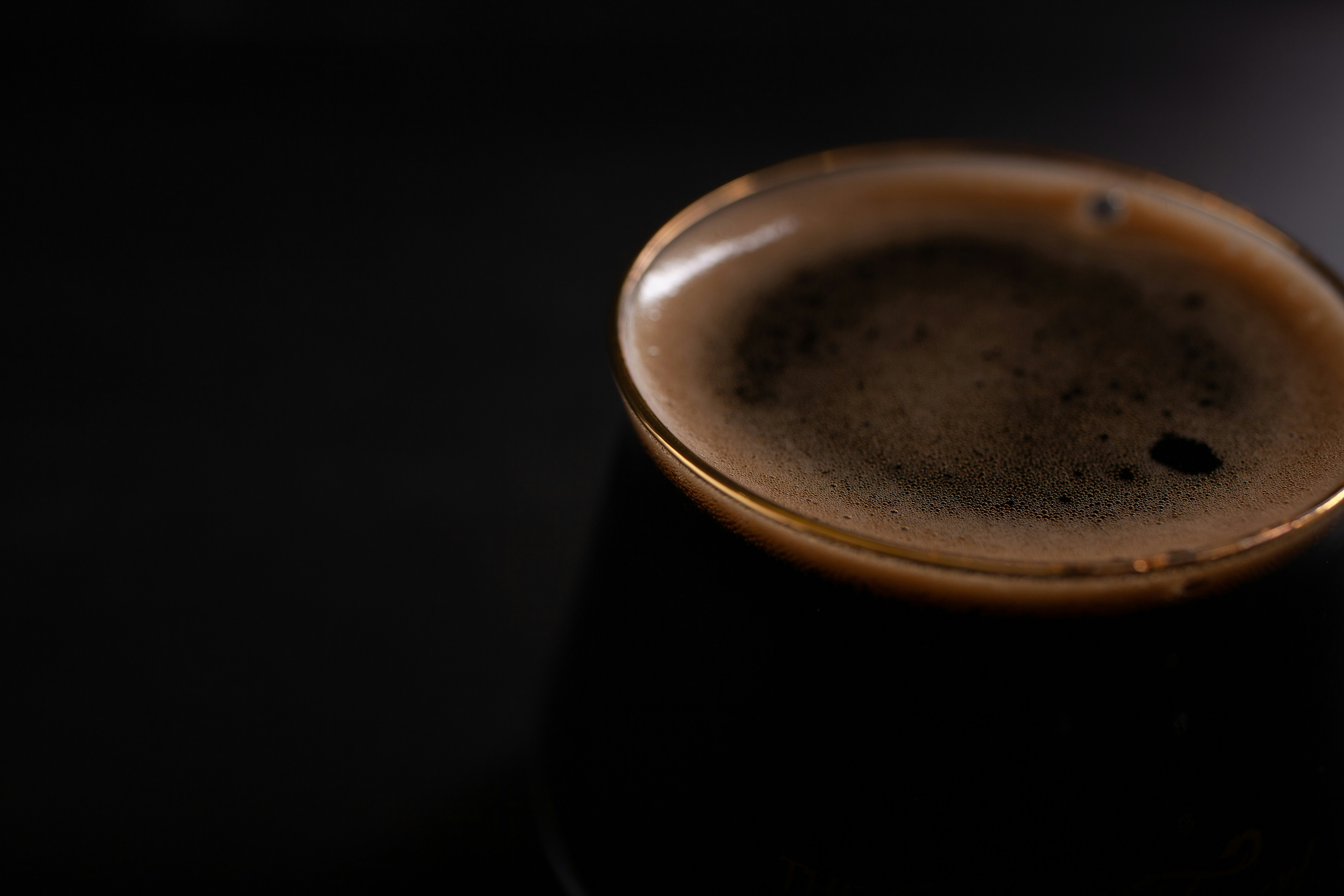 black ceramic mug with brown liquid